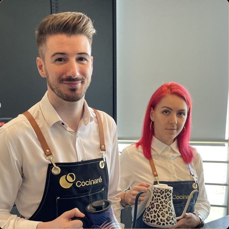 Baristas wearing Cocinare aprons with a Cocinare gooseneck kettle